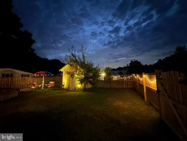 view of yard featuring a fenced backyard and a gate