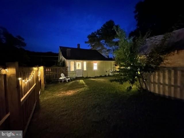 exterior space featuring a lawn and a fenced backyard