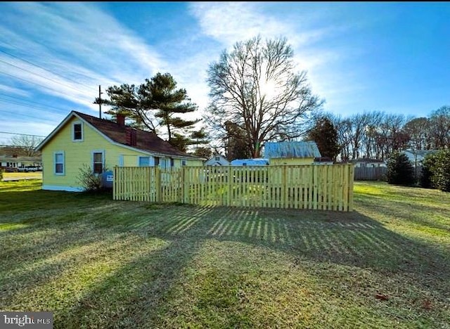 exterior space featuring a yard and fence