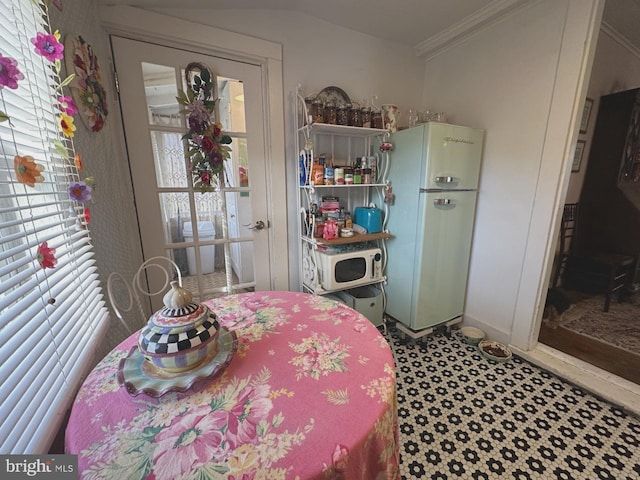 interior space featuring crown molding and freestanding refrigerator