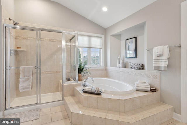 full bathroom featuring a stall shower, tile patterned flooring, vaulted ceiling, and a bath