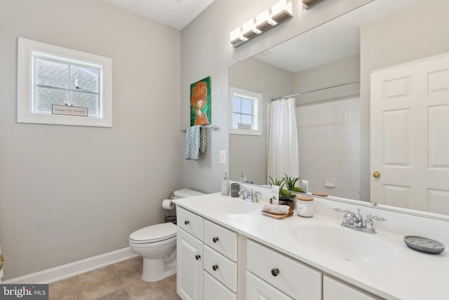 full bathroom with baseboards, double vanity, a sink, and tile patterned floors