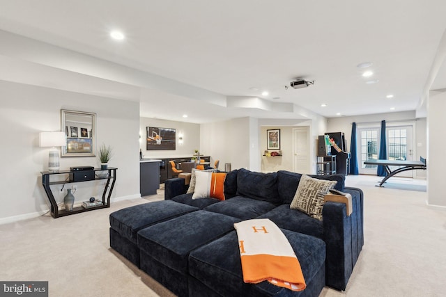 living area with recessed lighting, baseboards, and light colored carpet