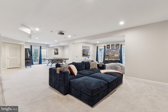 living room featuring light carpet, recessed lighting, and baseboards