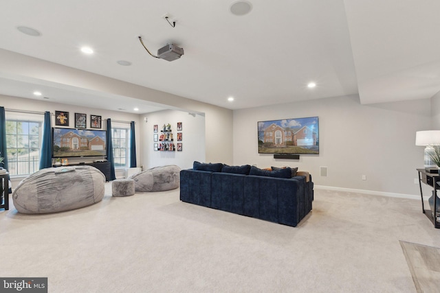 living room featuring recessed lighting, light carpet, and baseboards