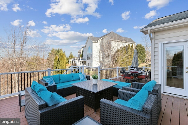 wooden deck with an outdoor hangout area and outdoor dining space