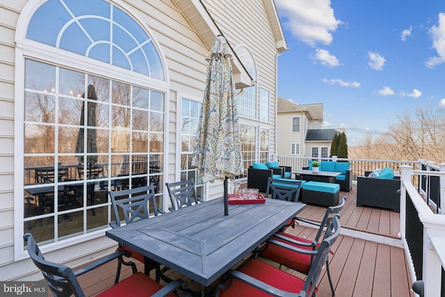 wooden deck featuring an outdoor living space and outdoor dining space