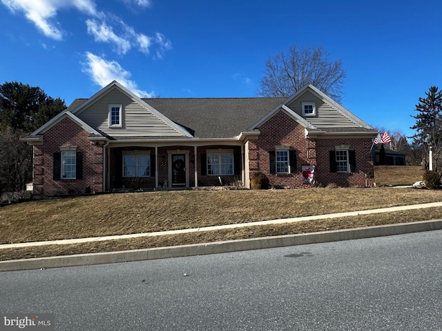 view of front facade featuring a front yard and brick siding