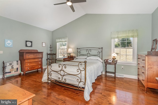 bedroom featuring a ceiling fan, vaulted ceiling, baseboards, and wood finished floors