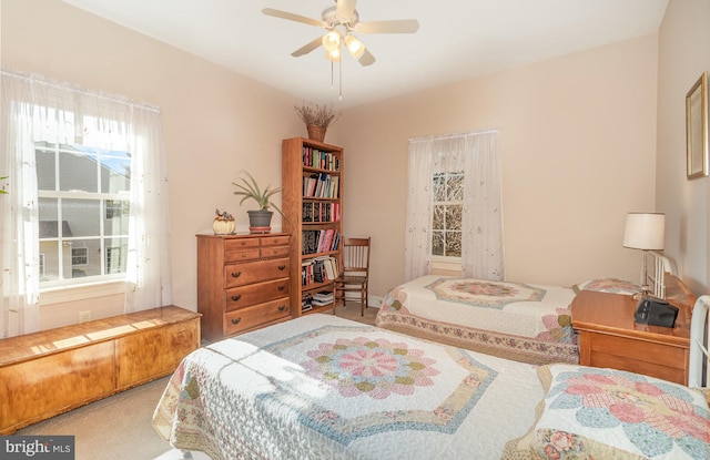 bedroom with carpet floors, multiple windows, and a ceiling fan