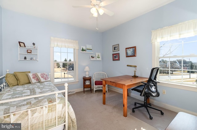 bedroom with light carpet, ceiling fan, visible vents, and baseboards