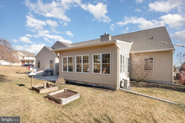 rear view of property with ac unit, roof with shingles, a yard, and a chimney