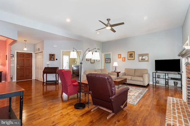 living area featuring ceiling fan, wood finished floors, and recessed lighting