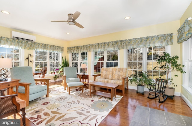 sunroom / solarium featuring ceiling fan and an AC wall unit