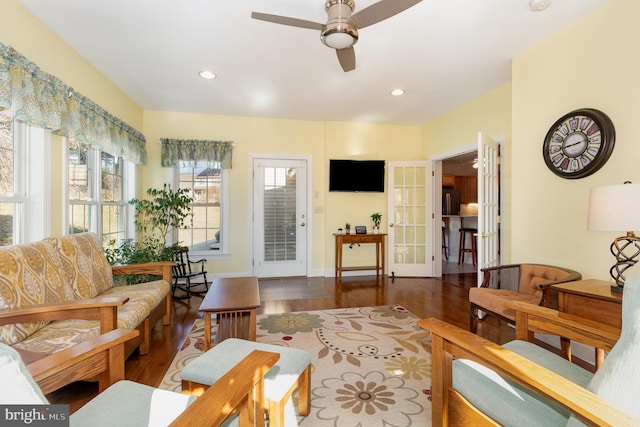 living room featuring a wealth of natural light, french doors, ceiling fan, and wood finished floors