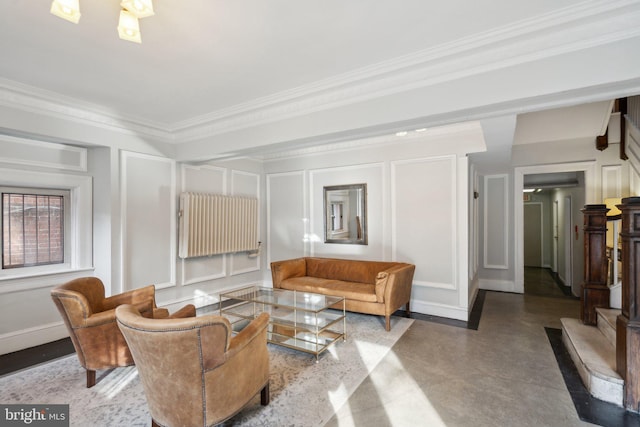 living room with baseboards, a decorative wall, and crown molding