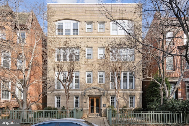 view of building exterior featuring a fenced front yard