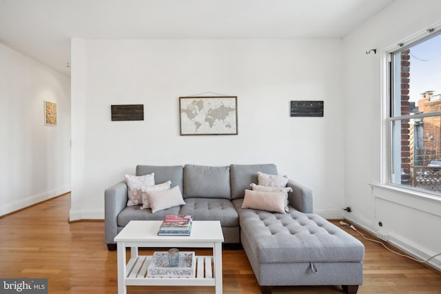 living room featuring light wood finished floors and baseboards