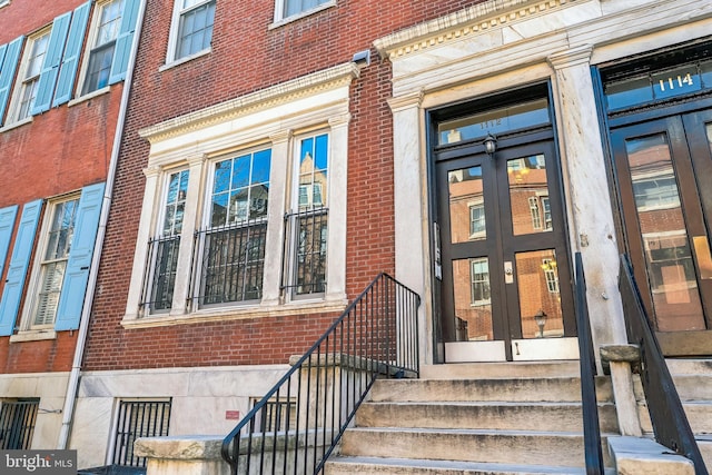 doorway to property with brick siding