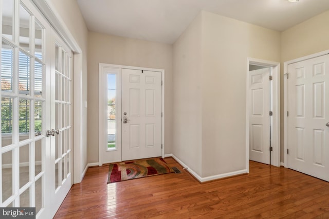 entrance foyer with wood finished floors and baseboards