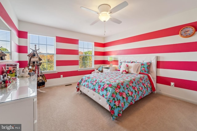 bedroom with carpet floors, visible vents, ceiling fan, and baseboards