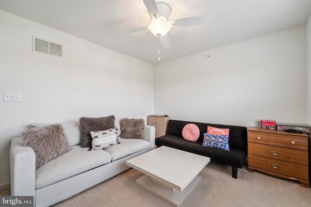 living area with ceiling fan, visible vents, and light colored carpet