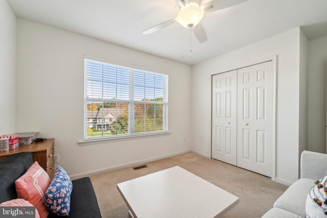 sitting room with light carpet, visible vents, and baseboards