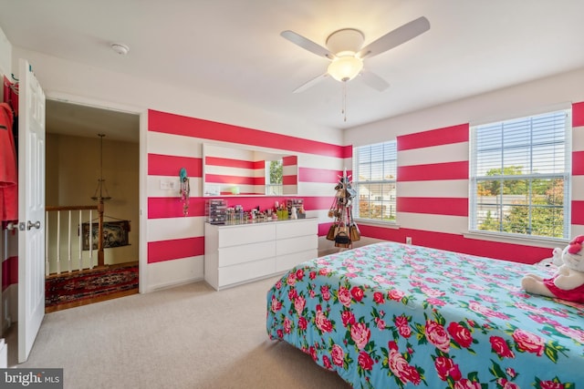 bedroom featuring light carpet and ceiling fan