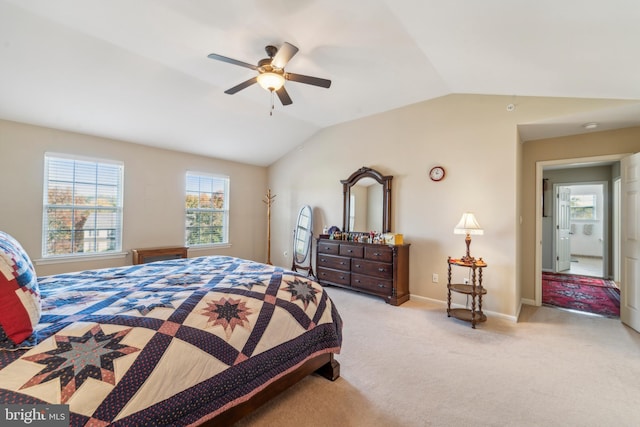 bedroom featuring vaulted ceiling, baseboards, a ceiling fan, and light colored carpet