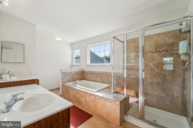 full bath with a garden tub, a stall shower, a sink, and tile patterned floors