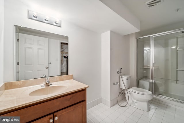 bathroom with a shower stall, visible vents, vanity, and toilet