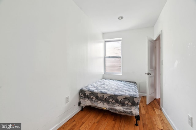 bedroom featuring light wood-style floors and baseboards