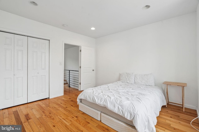 bedroom featuring recessed lighting, a closet, baseboards, and wood finished floors