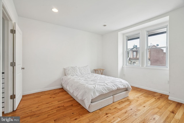 bedroom featuring recessed lighting, light wood-style flooring, and baseboards