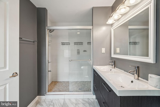 bathroom featuring double vanity, marble finish floor, a sink, and a stall shower