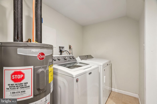 washroom featuring electric water heater, light tile patterned flooring, laundry area, independent washer and dryer, and baseboards