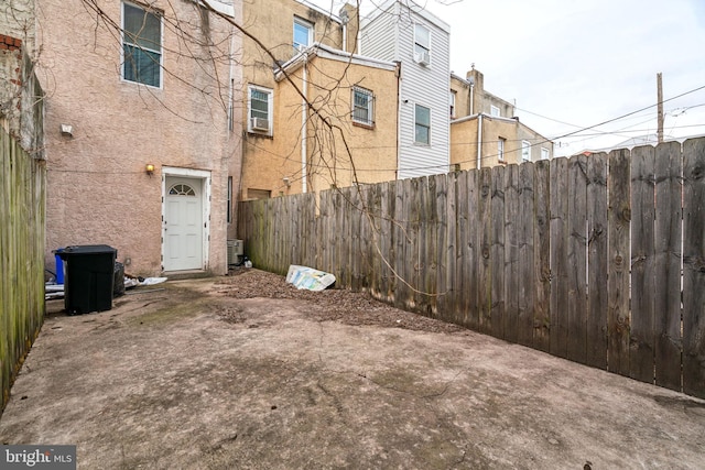 view of yard with central AC unit and fence