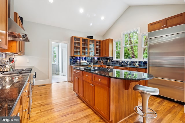 300 E Broad St, Falls Church, VA 22046 - kitchen with stainless steel built in refrigerator, backsplash, light wood-style floors, brown cabinets, and recessed lighting