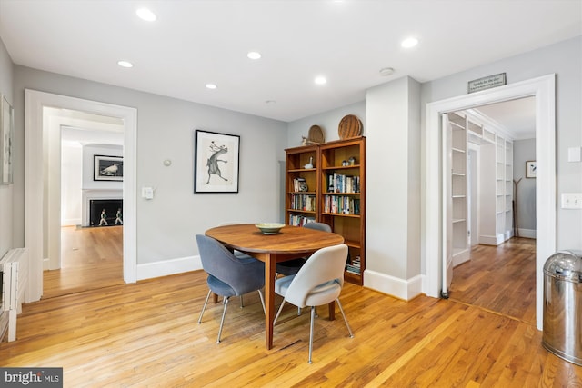 300 E Broad St, Falls Church, VA 22046 - dining space featuring light wood finished floors, a fireplace, and recessed lighting