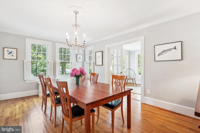 300 E Broad St, Falls Church, VA 22046 - dining space with a chandelier, healthy amount of natural light, ornamental molding, and light wood-style flooring