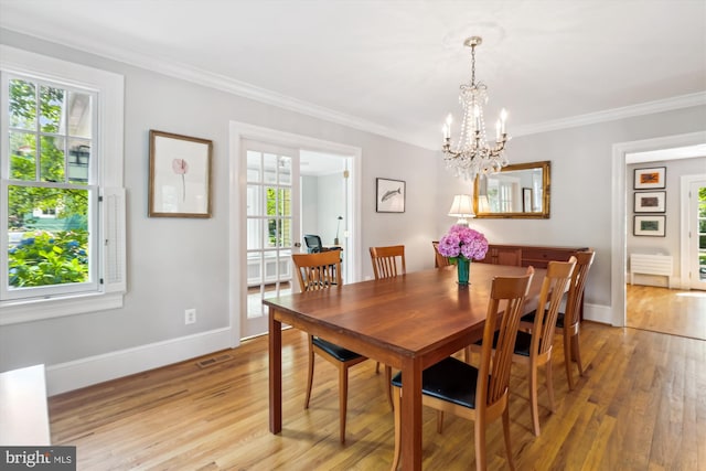 300 E Broad St, Falls Church, VA 22046 - dining space featuring light wood finished floors, a chandelier, and ornamental molding