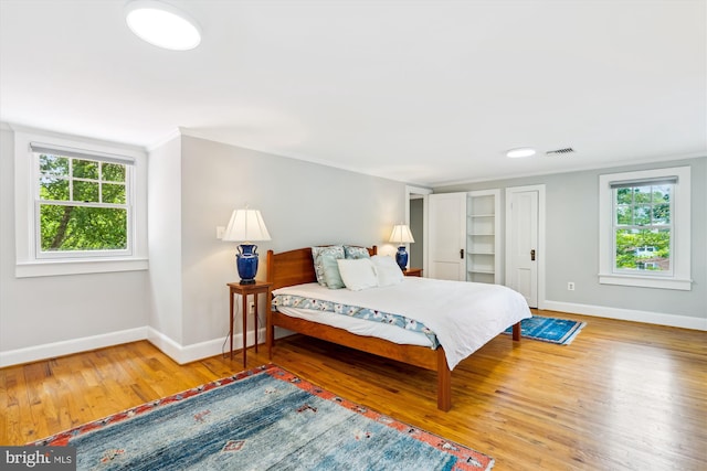 300 E Broad St, Falls Church, VA 22046 - bedroom with wood finished floors and multiple windows