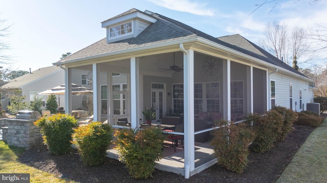 view of home's exterior featuring french doors, a shingled roof, area for grilling, a sunroom, and cooling unit