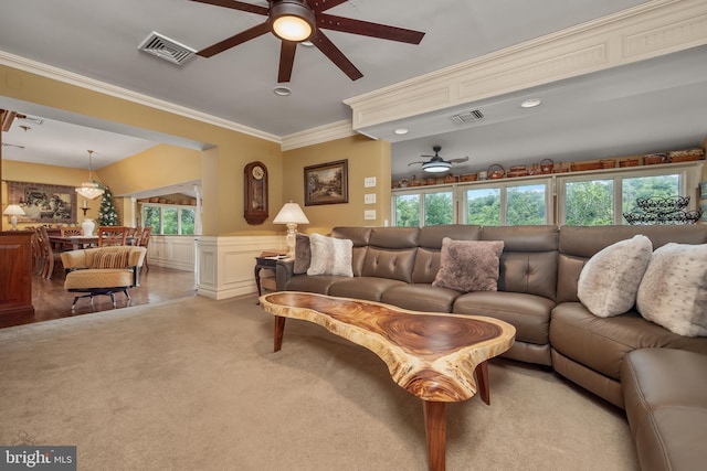 living room featuring ceiling fan, visible vents, a wealth of natural light, and wainscoting