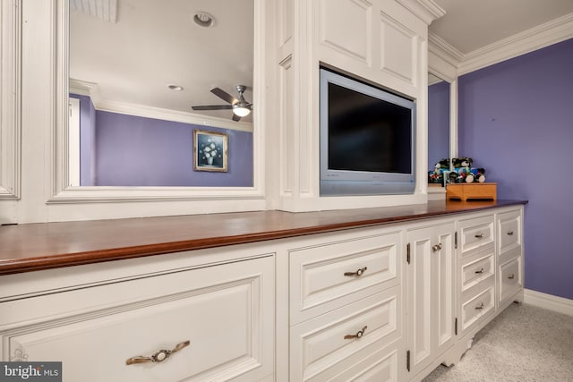 room details featuring ornamental molding, carpet, baseboards, and a ceiling fan