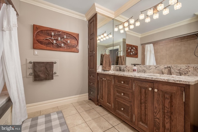 full bath with crown molding, double vanity, a sink, tile patterned flooring, and baseboards