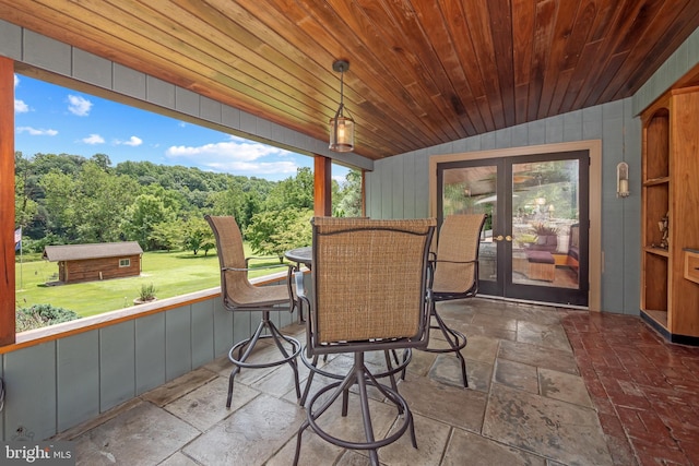 exterior space with lofted ceiling, wooden ceiling, and french doors