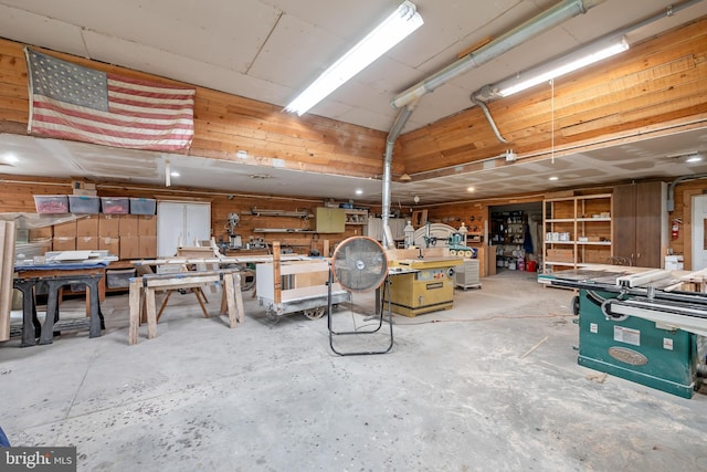 interior space with unfinished concrete flooring and a workshop area