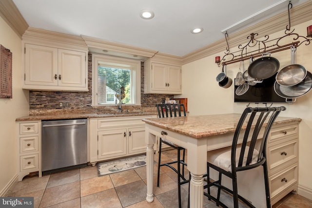 kitchen with decorative backsplash, cream cabinets, stainless steel dishwasher, ornamental molding, and a sink