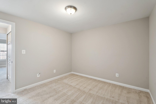 carpeted spare room with baseboards